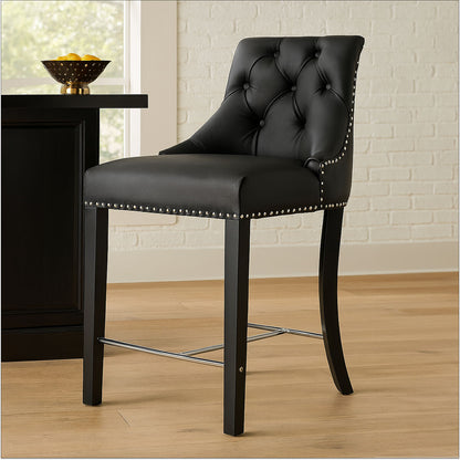 Black bar stool with tufted backrest and nailhead trim in a room setting.