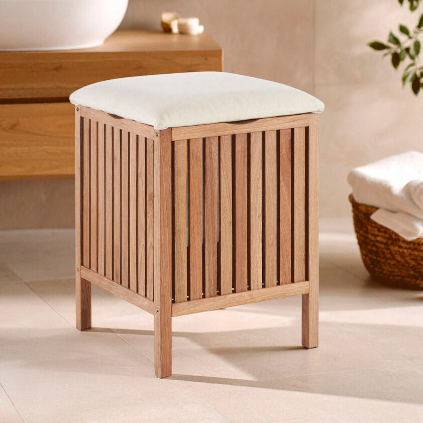 Wooden stool with a white cushion in a bathroom setting