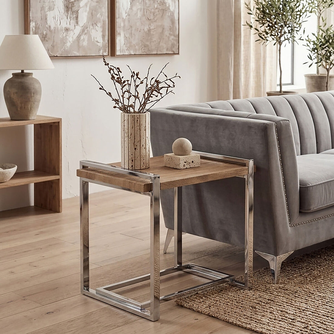 Modern living room with a gray sofa, wooden side table, and decorative elements.