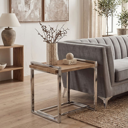 Modern living room with a gray sofa, wooden side table, and decorative elements.