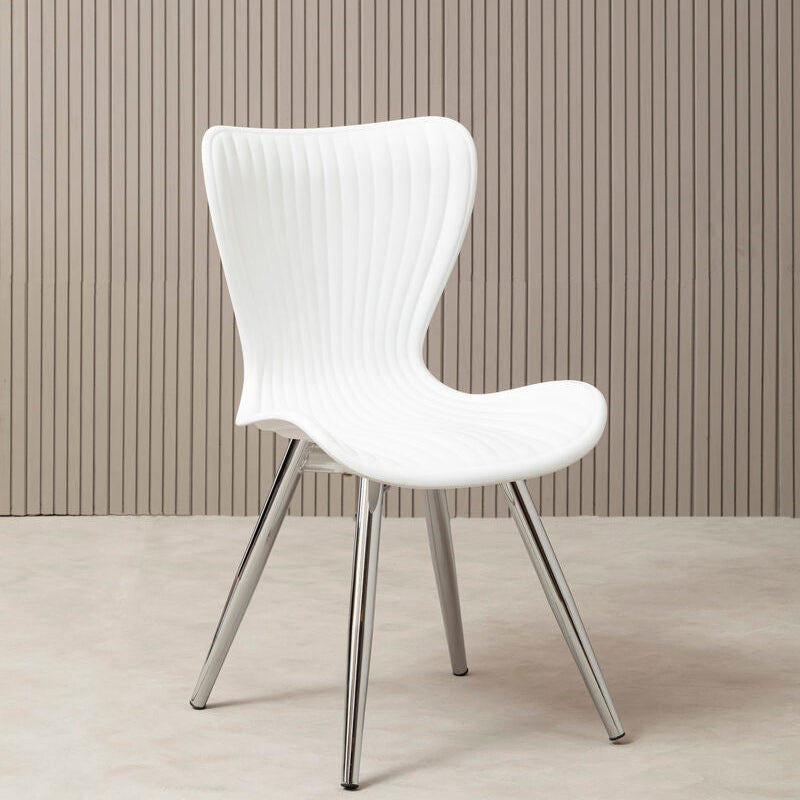 White chair with metal legs against a beige wall.