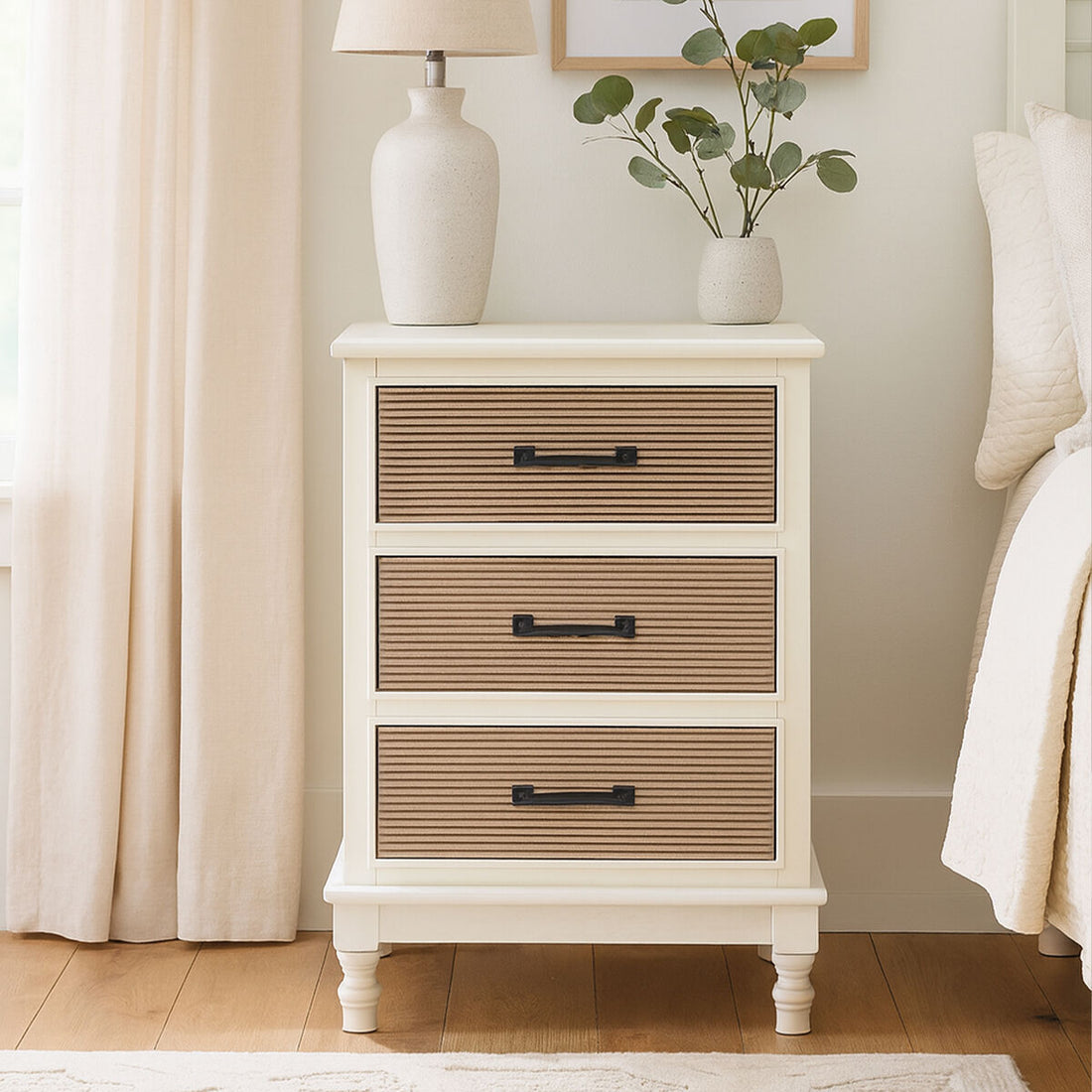 Wooden nightstand with three drawers in a bedroom setting.