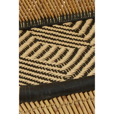 Close-up of a woven mat with black and beige pattern
