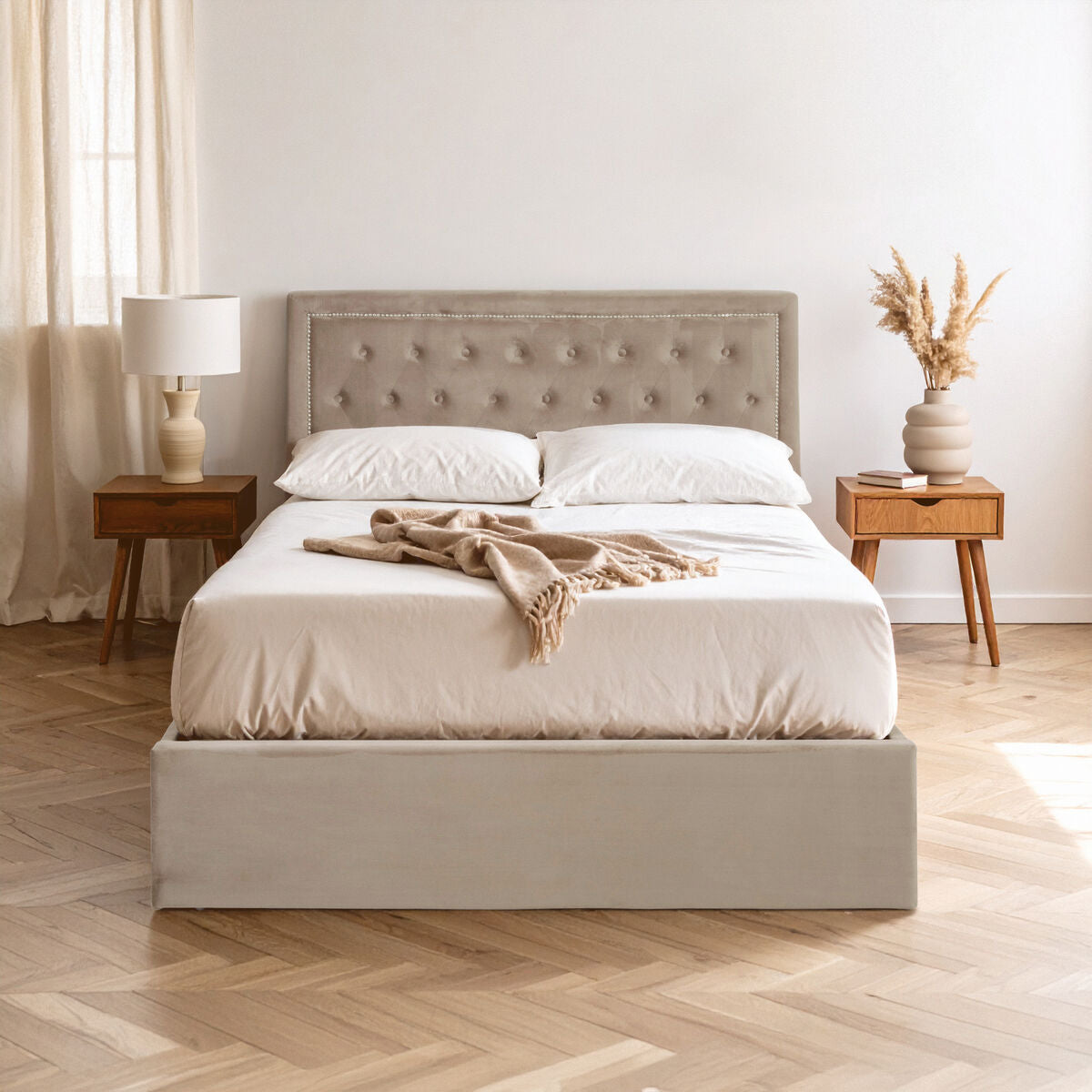 Beige upholstered bed with white bedding in a bedroom setting.