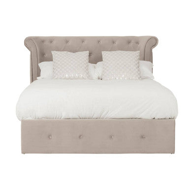 Beige upholstered bed with white bedding on a white background