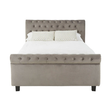 Gray upholstered bed with white bedding on a white background