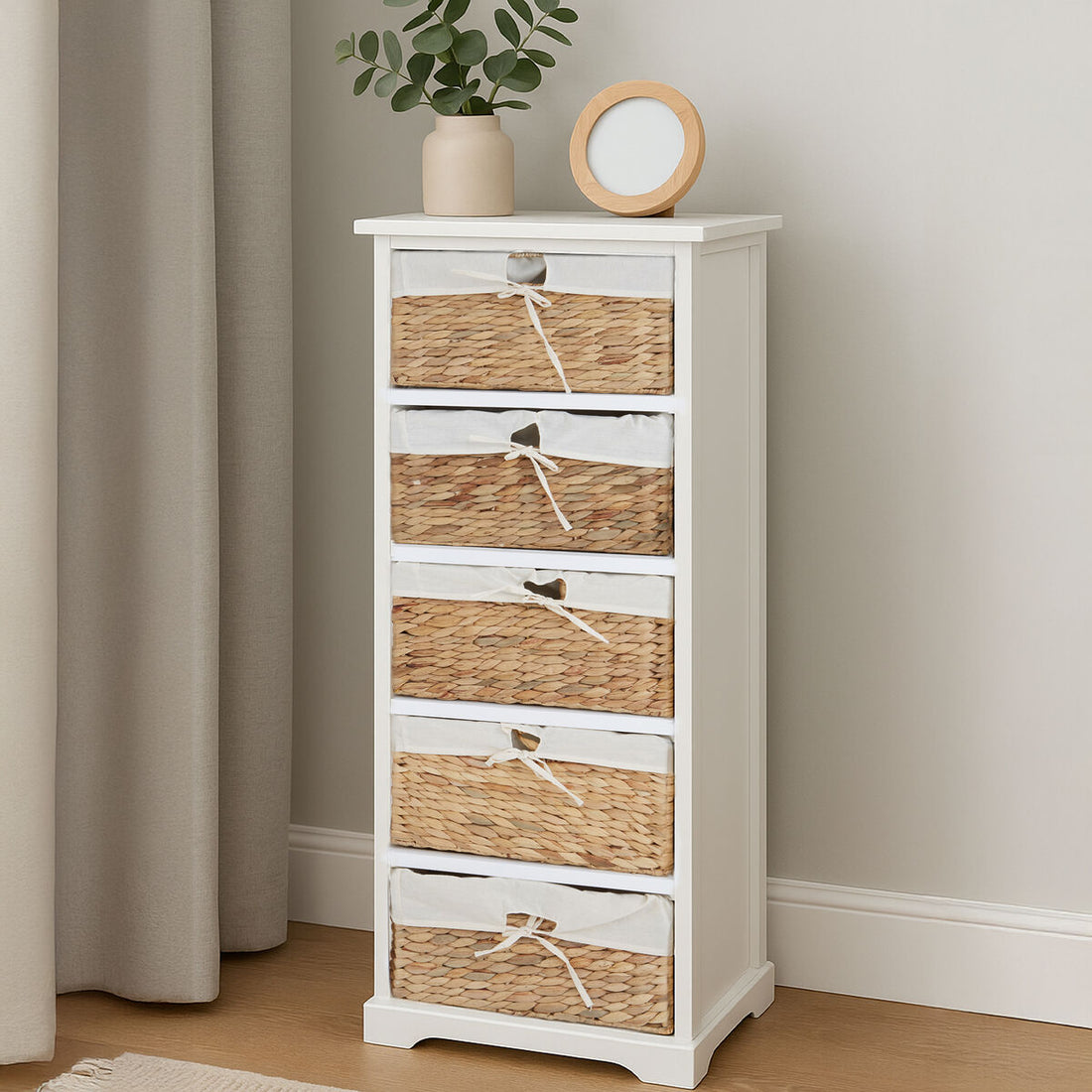 White cabinet with wicker drawers against a neutral wall
