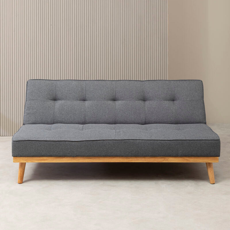 Gray sofa bed with wooden frame against a neutral wall