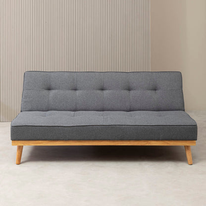 Gray sofa bed with wooden frame against a neutral wall