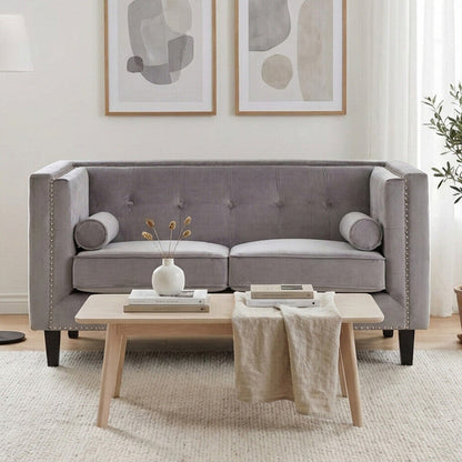 Gray sofa in a living room with abstract art and a coffee table.