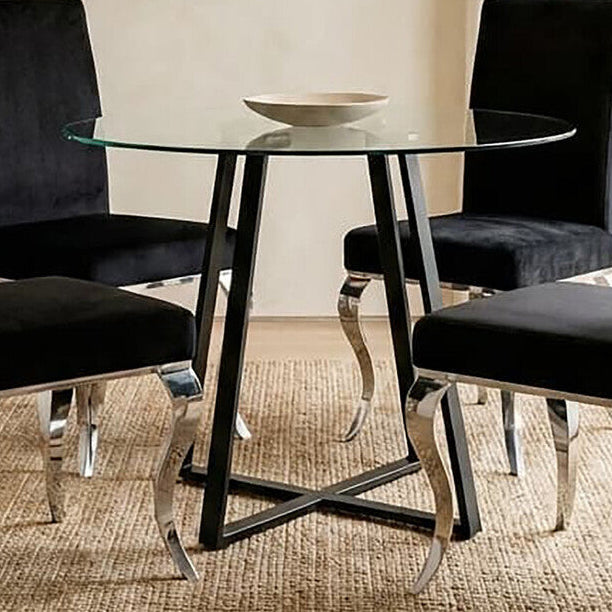 Dining room with black chairs and a glass table.