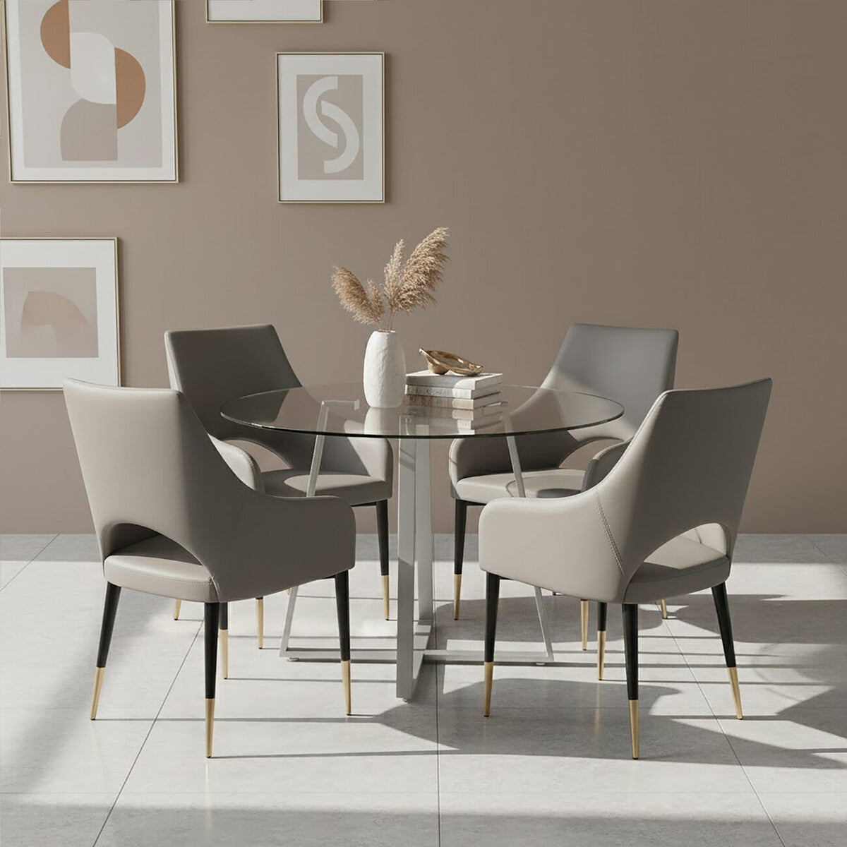 Dining room with a round glass table and four chairs against a beige wall with abstract art.