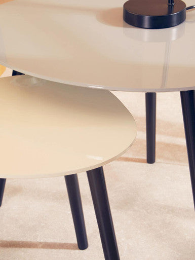 Two round tables with black legs on a light-colored floor.