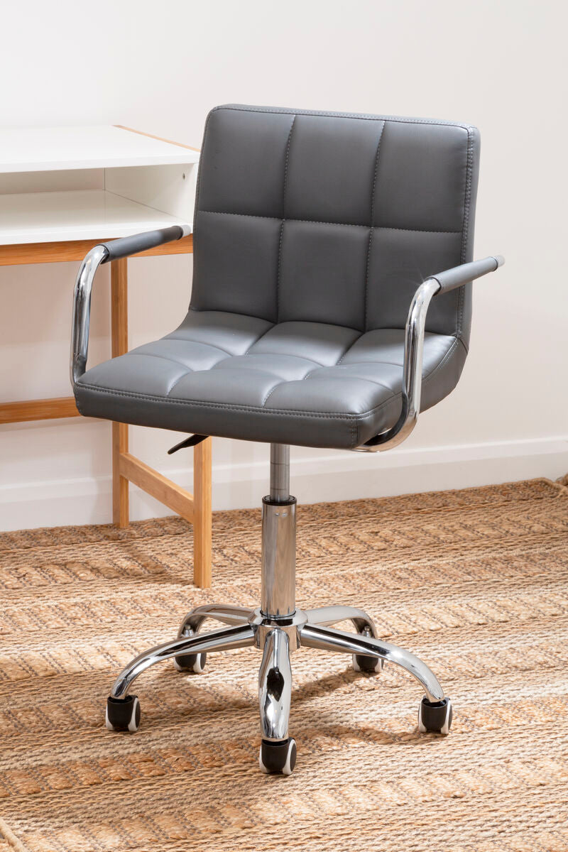 Gray office chair with chrome base in front of a desk.