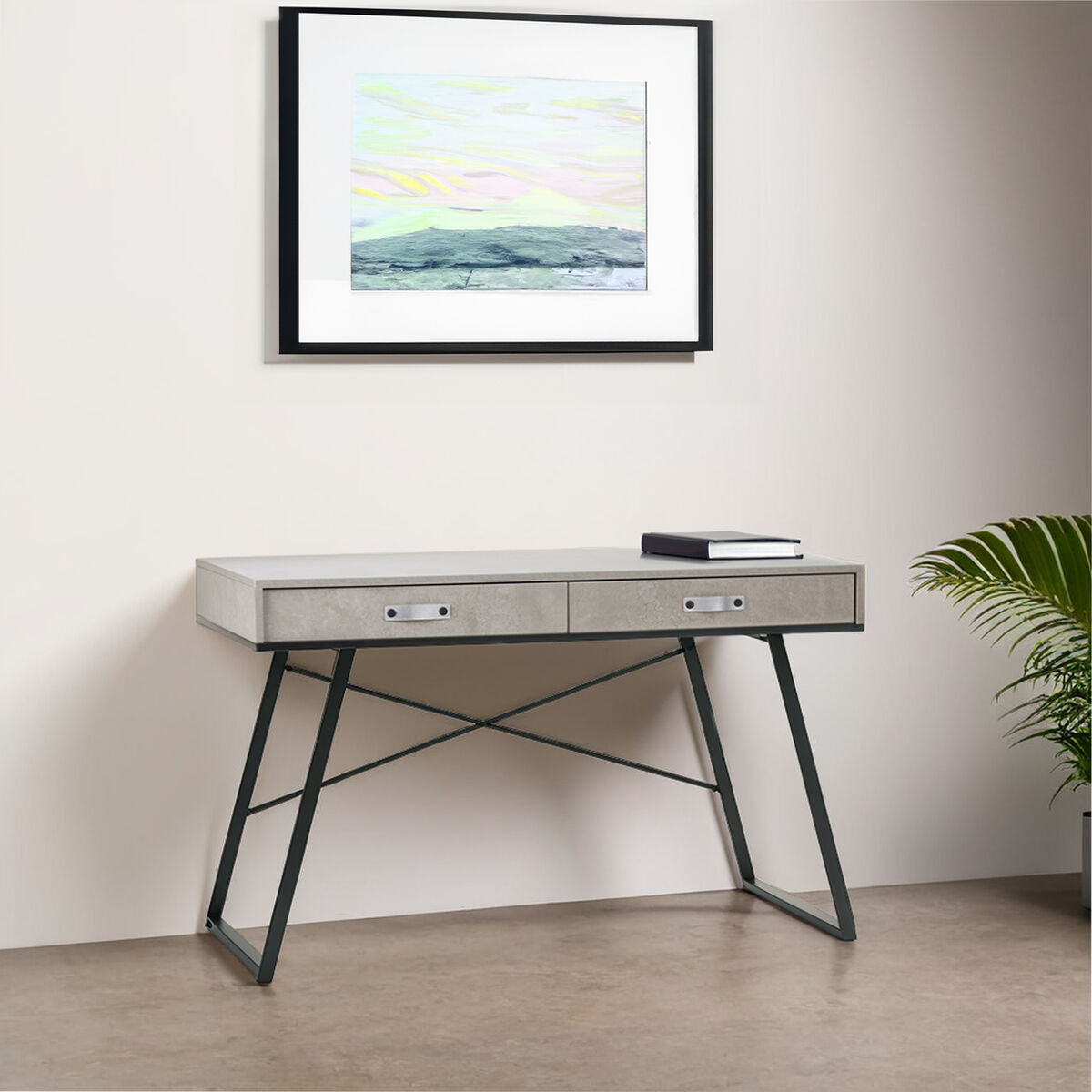 Modern desk with a framed artwork above it in a minimalistic room.