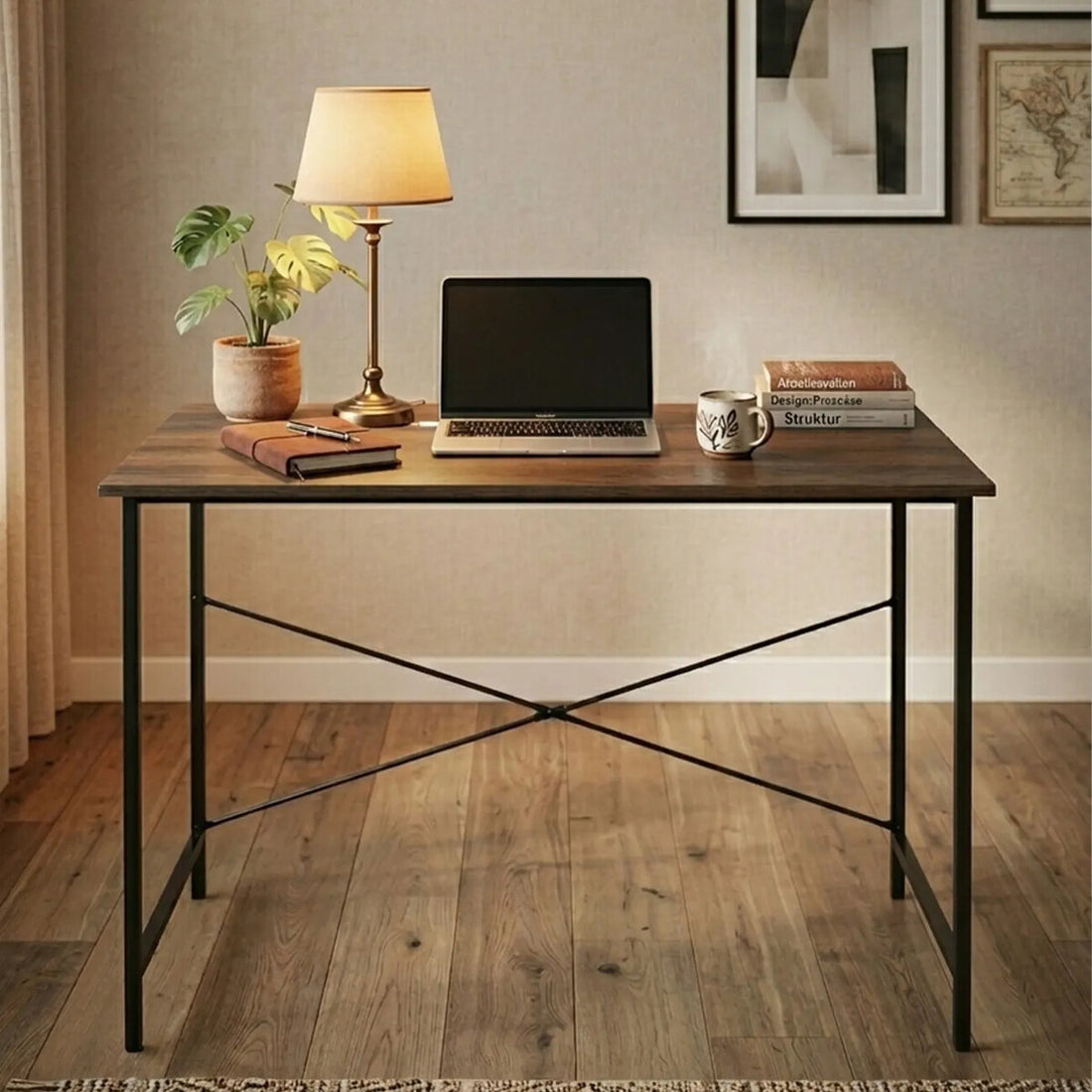 Wooden desk with laptop, books, and decor items in a home office setting.