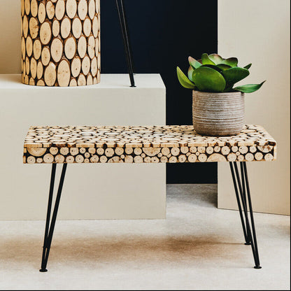 Wooden bench with circular cutout design on a plain background