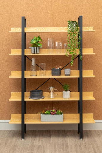 Wooden shelf with black metal frame against a brown wall