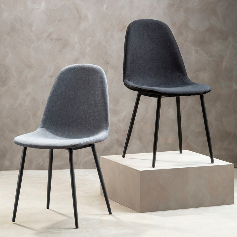 Two modern chairs, one gray and one black, against a textured wall.