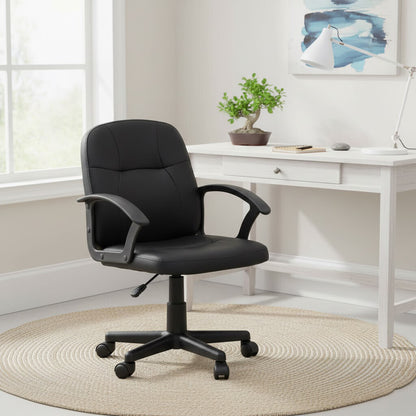 Black office chair in a home office setting with a desk and decor.