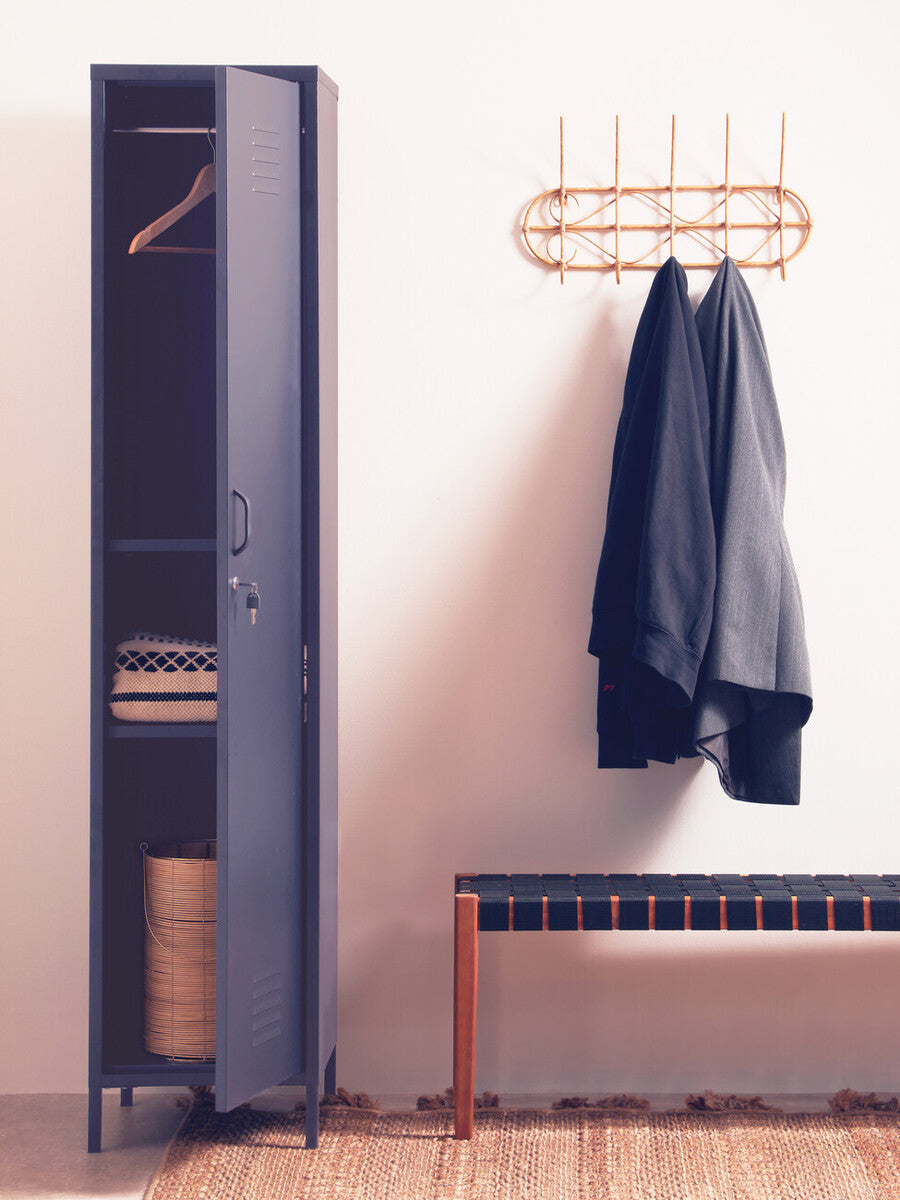 Blue locker with open door, clothes hanging on a rack, and a bench against a white wall.