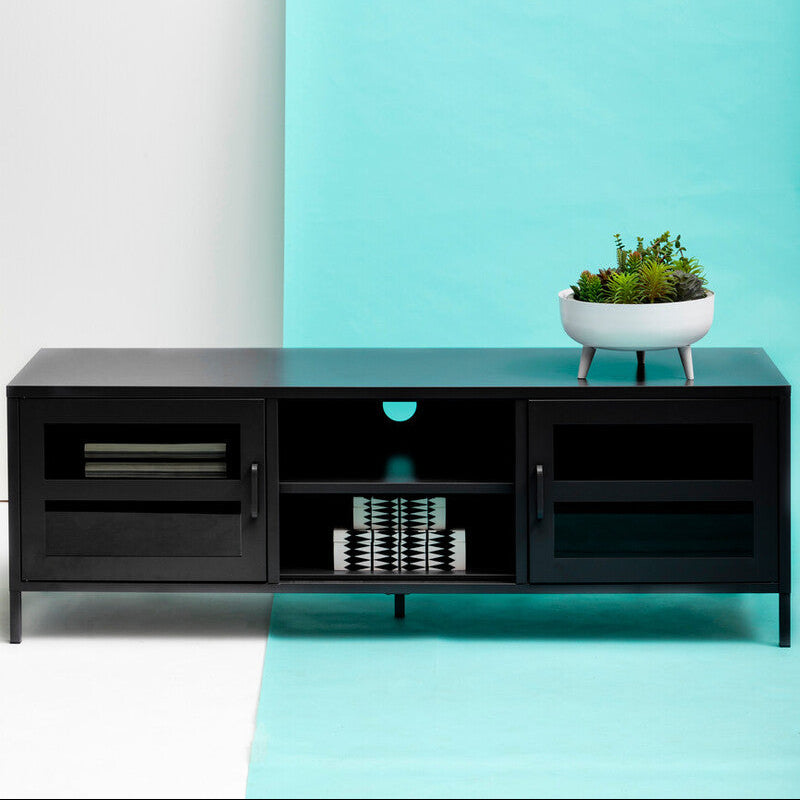 Black entertainment console against a white and blue gradient wall with a plant on top.