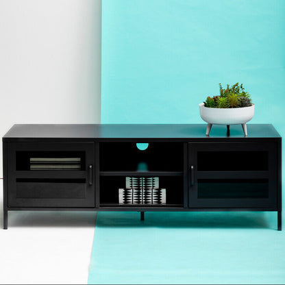 Black entertainment console against a white and blue gradient wall with a plant on top.