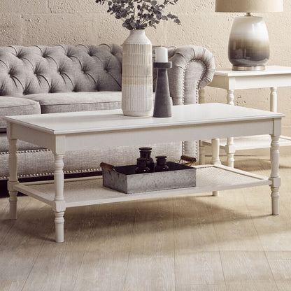 Living room with gray sofa, white coffee table, and decorative items.