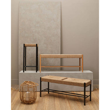 Three pieces of furniture including a bench, shelf, and basket against a neutral wall.