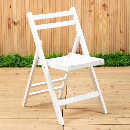 White folding chair on a wooden deck with a wooden fence and greenery in the background