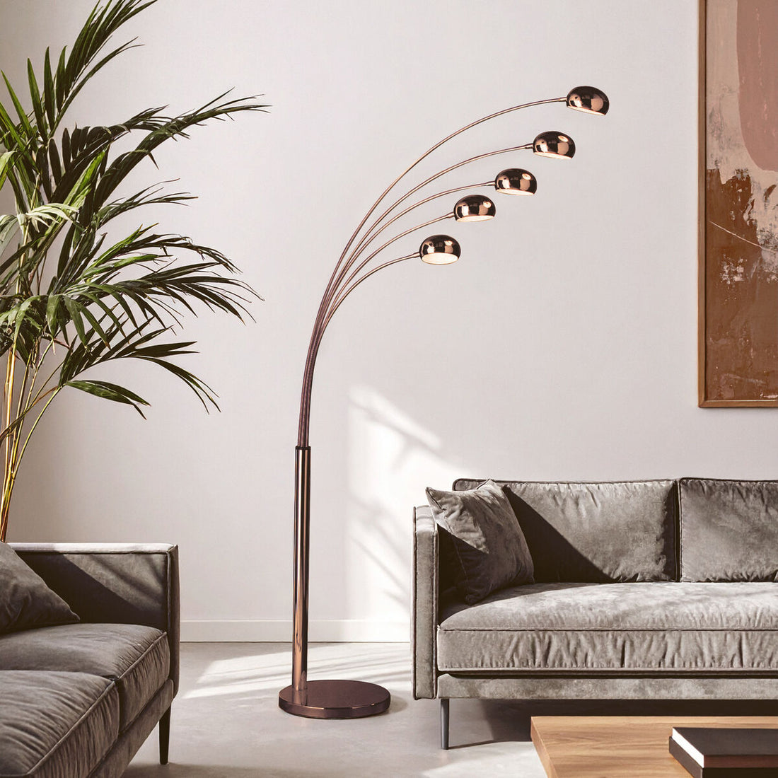 Modern living room with a floor lamp, gray sofa, and plant.
