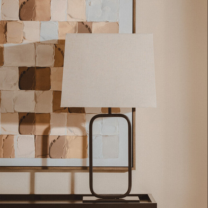 Table lamp on a console table with a textured wall in the background