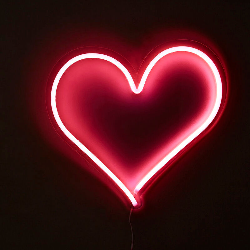 Neon heart shape light on a black background