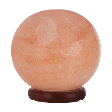 Himalayan salt lamp in spherical shape on a white background
