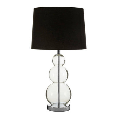 Table lamp with black shade and glass base on a white background