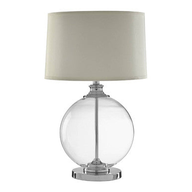 Table lamp with clear glass base and beige fabric shade on a white background