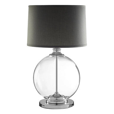 Table lamp with clear glass base and dark gray shade on a white background