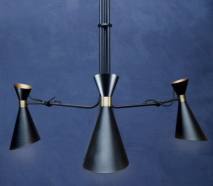 Modern black chandelier with gold accents against a blue background