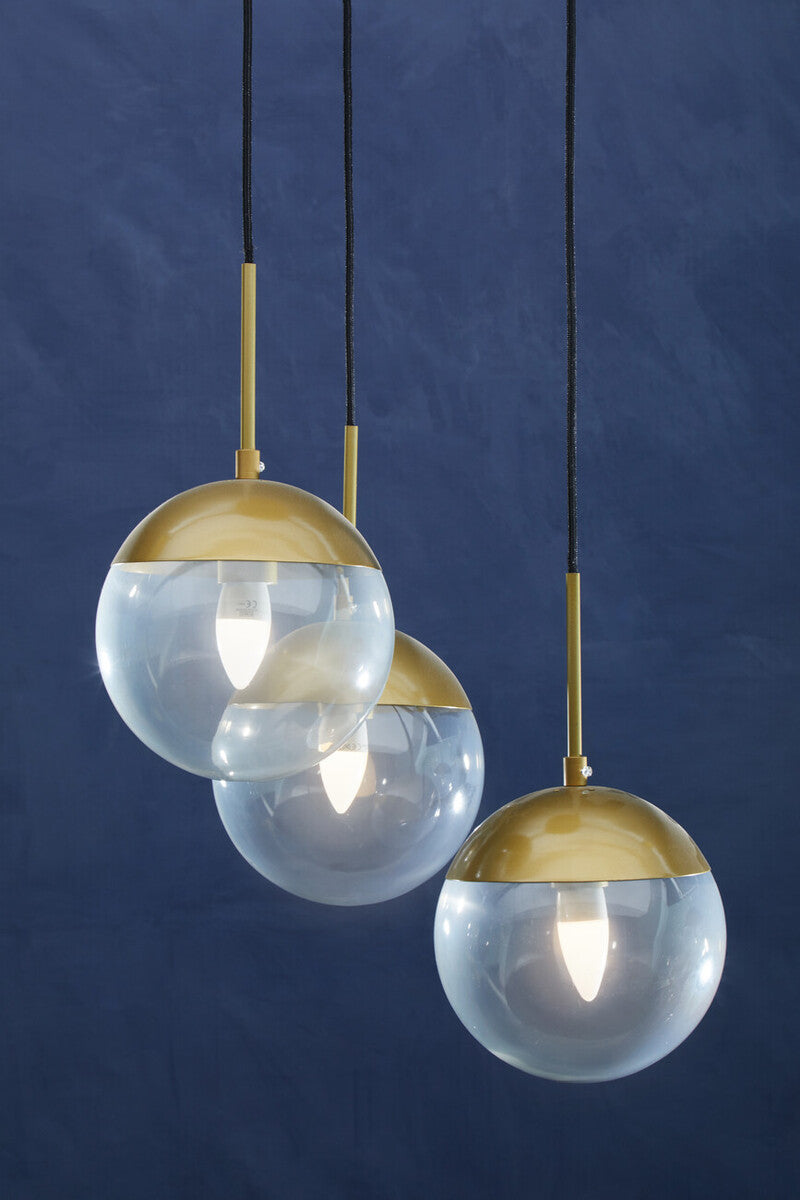 Three pendant lights with gold accents on a dark blue background