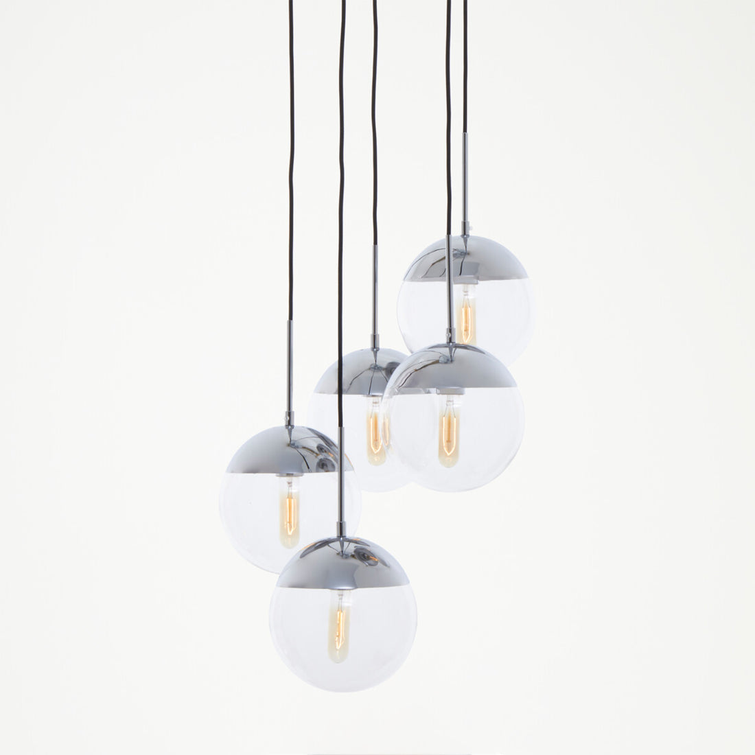 Set of four pendant lights with glass shades and chrome fixtures on a white background