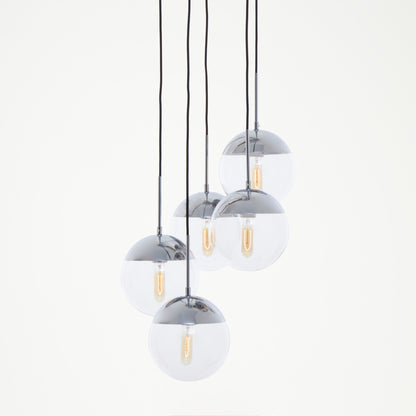 Set of four pendant lights with glass shades and chrome fixtures on a white background