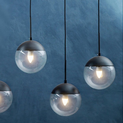 Modern pendant lights with glass shades on a blue background