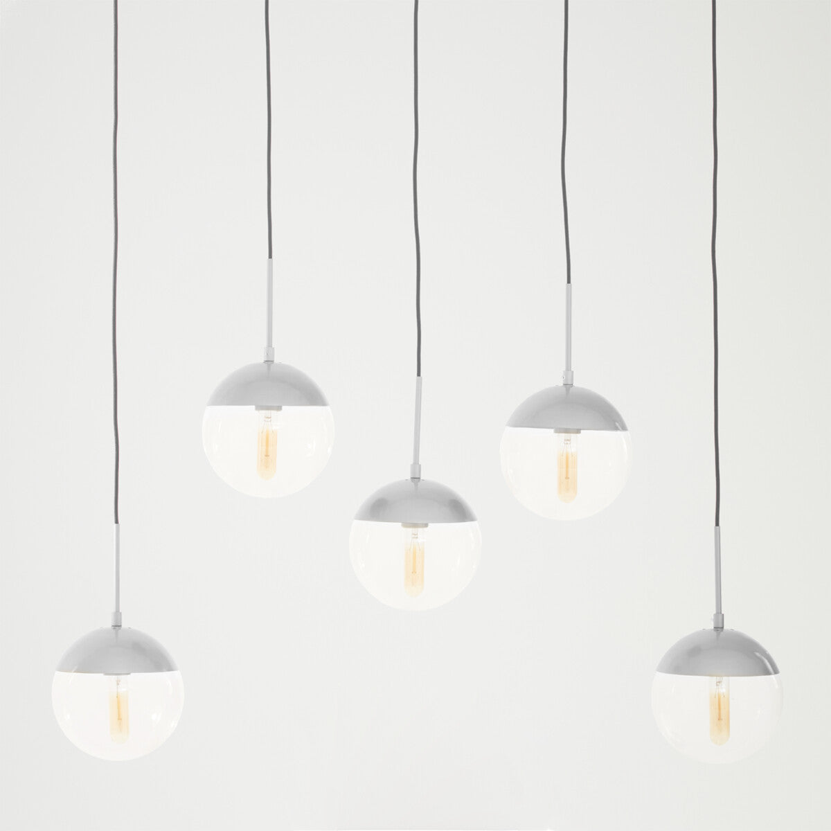 Set of five pendant lights with gray fixtures on a white background