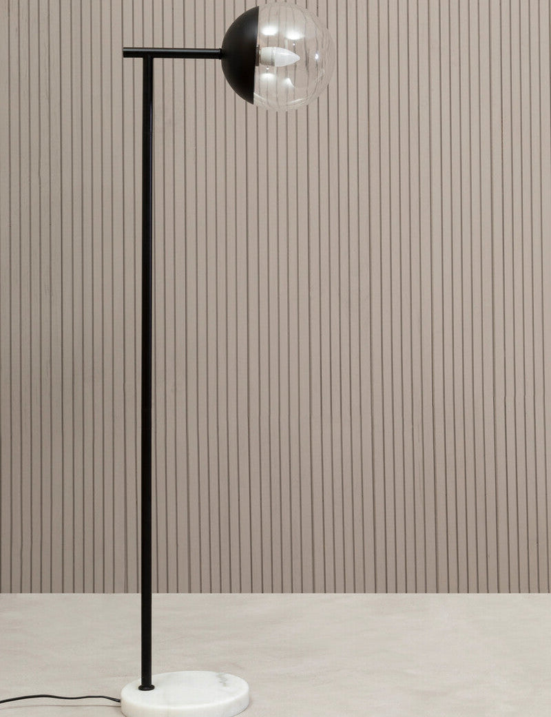 Modern floor lamp with a black and silver design on a neutral background