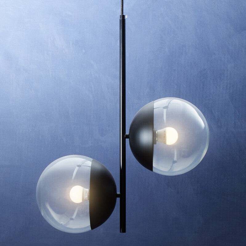 Modern pendant light with glass shades on a blue background