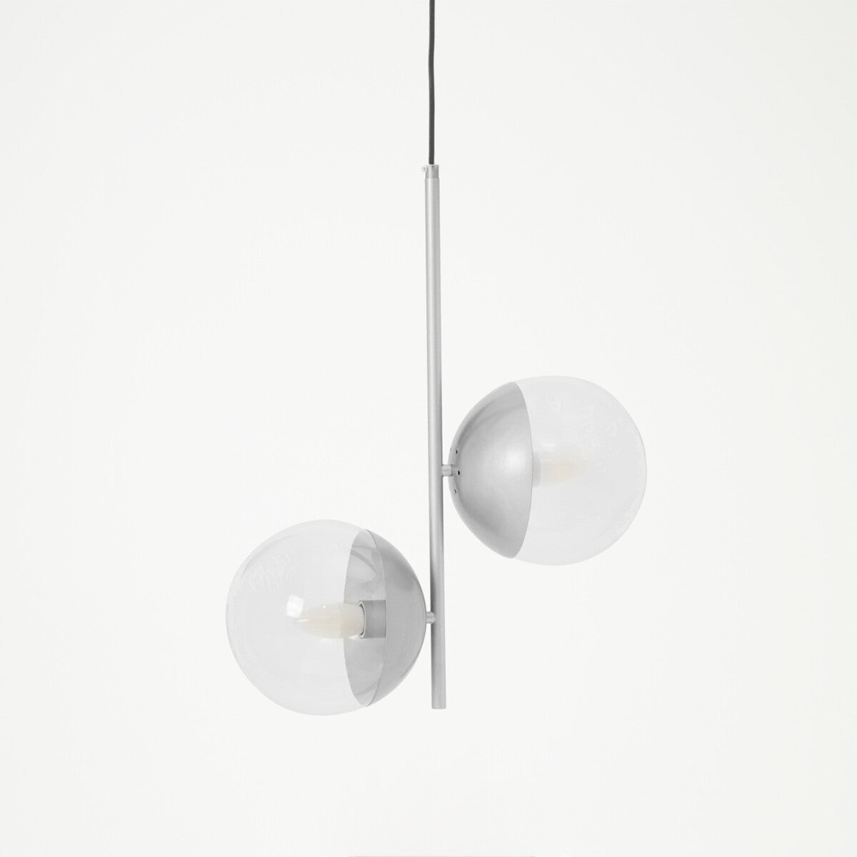 Modern pendant light with three spherical glass shades on a white background