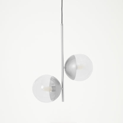 Modern pendant light with three spherical glass shades on a white background