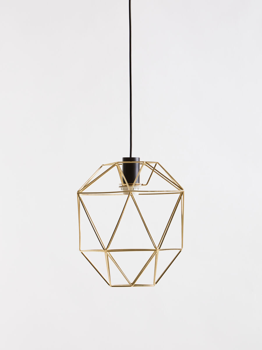 Gold geometric pendant light on a white background