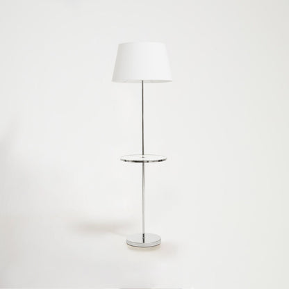 Floor lamp with a white shade and chrome base on a white background