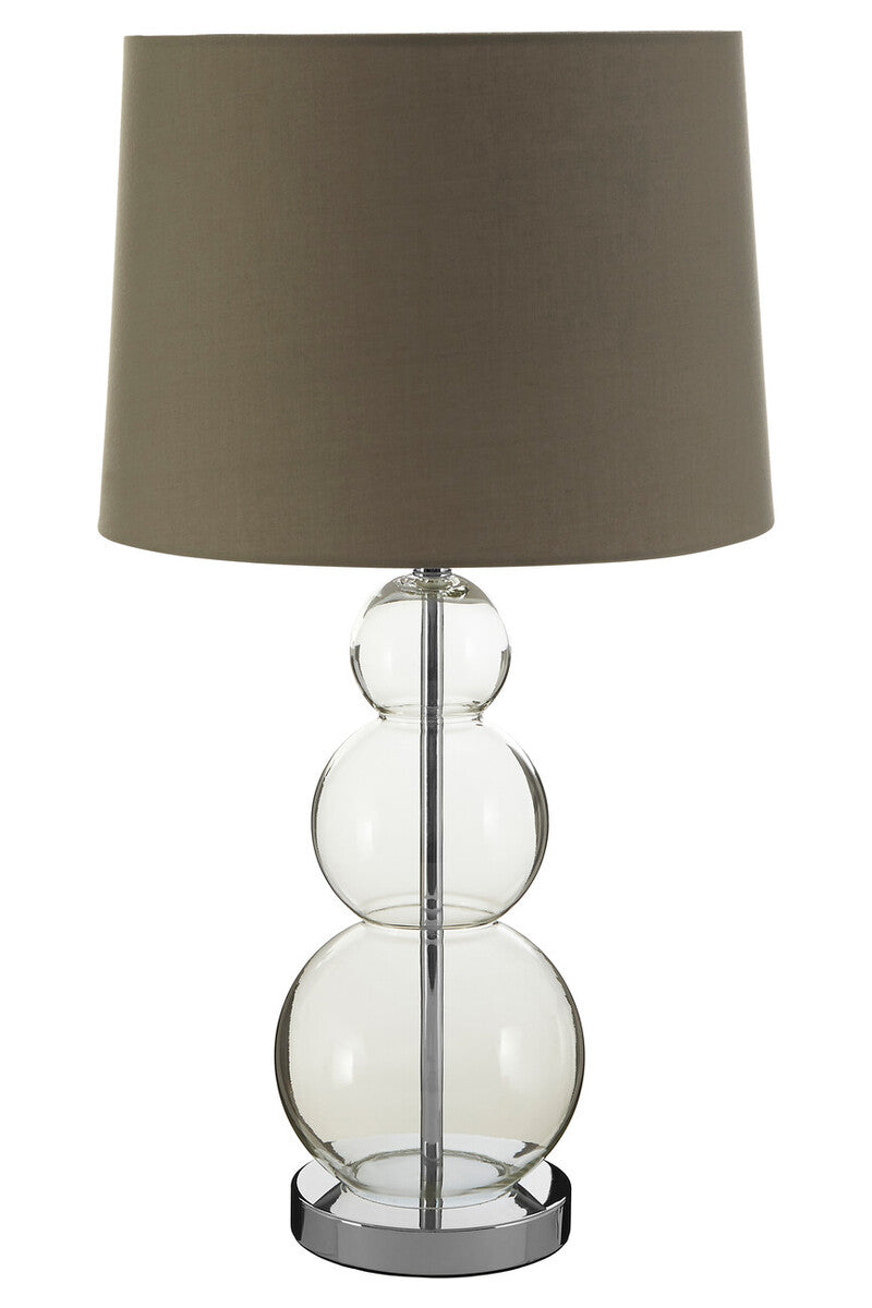 Table lamp with clear glass base and dark brown shade on a white background